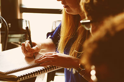 Student writing in a notebook